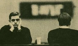 two young bankers looking morose 