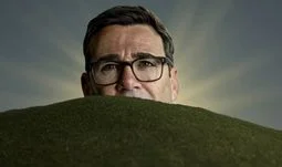 Andy Burnham behind a hill with sunrays