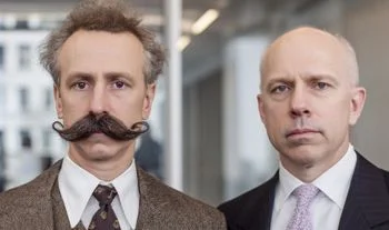 a banker with a moustache in a tweed suit standing next to a Goldman banker 