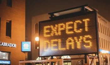 A sign that says Expect delays 