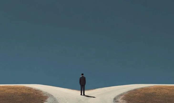 a banker standing at the fork in the road 