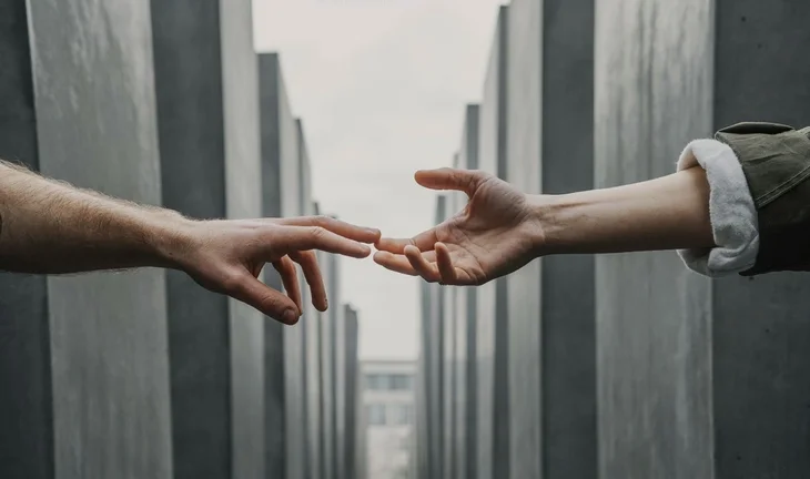 hands stretching to meet each other