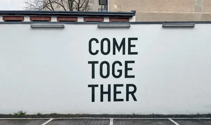 a sign that says come together