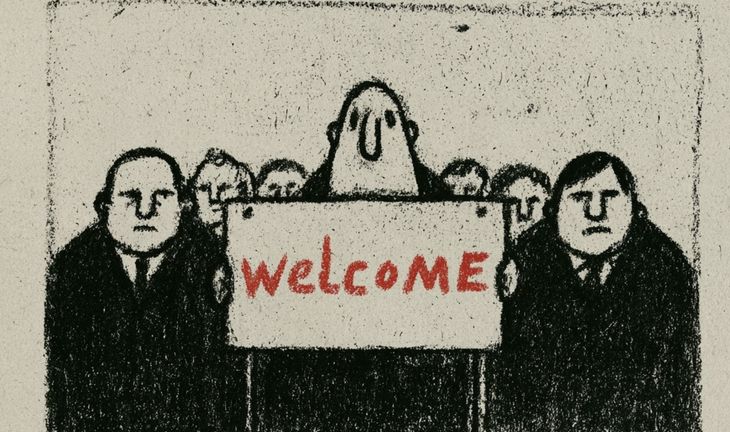 a banker holding a sign that says welcome in red