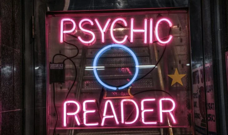 A sign that says psychic reader