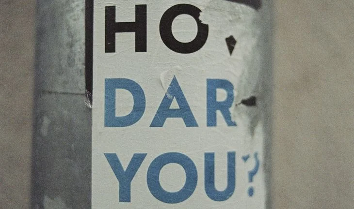 a sticker saying how dare you 