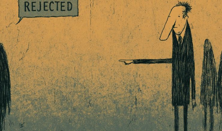 A man pointing and a sign that says rejected