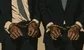 two hedge fund managers in handcuffs