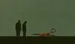 two men looking at some red scissors 