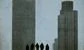 Two office buildings and five small black silhouettes of people