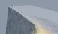 a man walking to the edge of a cliff 